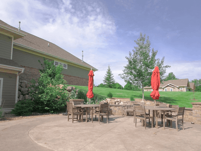 Outdoor patio area with tables and red umbrellas