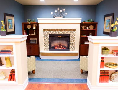 Cozy common area with a fireplace and bookshelves
