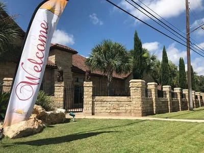 Exterior view of the facility with a welcome banner
