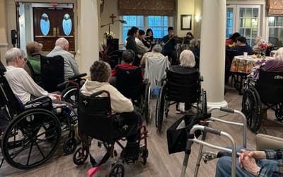 Residents enjoying a music performance in an activity room