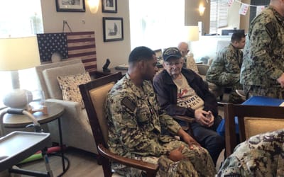 Veteran interacting with staff in a common area