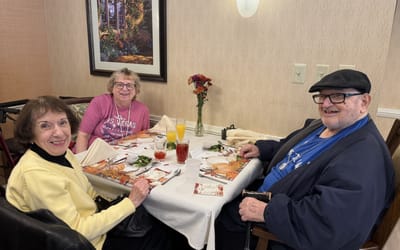 Residents enjoying a meal together in the dining area