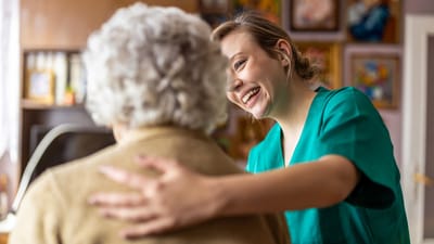 Staff member interacting with a resident in a cozy setting