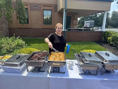 Staff serving food at an outdoor event
