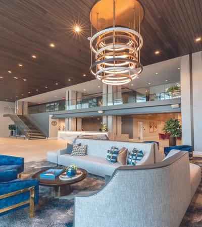 A modern lobby area with seating and decorative lighting