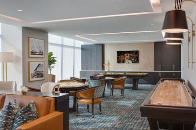 Brightly lit common area with gaming tables and seating
