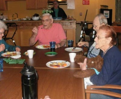 Residents enjoying a meal together in a dining area