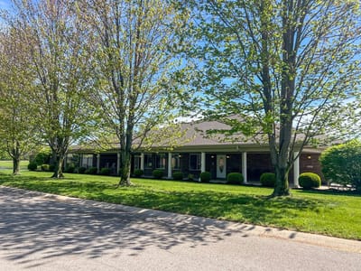 Exterior view of the assisted living facility surrounded by trees