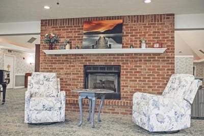 Cozy common area with a fireplace and chairs
