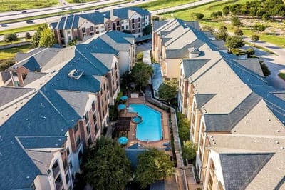 Aerial view of a senior living facility with pool and outdoor areas