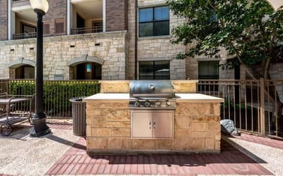 Outdoor grilling area with a stone backdrop