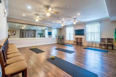 Interior activity room with yoga mats and seating