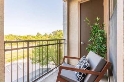 Balcony seating with a view of green landscaping