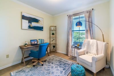 Cozy interior of a resident room with a desk and seating