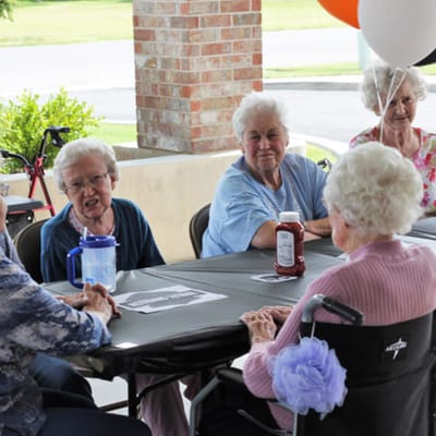 Residents enjoying a gathering with balloons outside