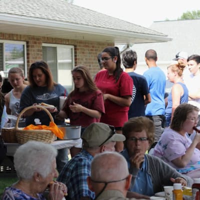 Residents and volunteers enjoying an outdoor event
