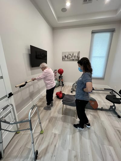 Residents engaging in rehabilitation exercises in a therapy room
