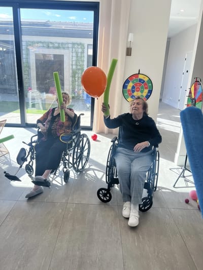 Residents engaging in an activity with noodle props