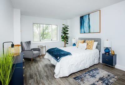 Brightly decorated resident room with a cozy bed