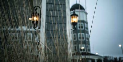 View of the facility exterior with lamp and grasses