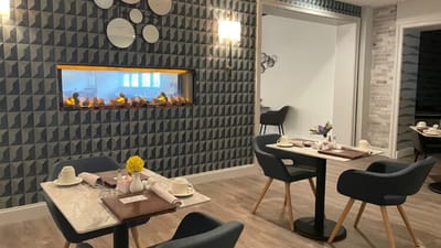 Dining area with modern decor and a fireplace