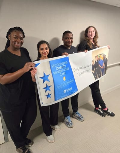Staff holding a banner celebrating quality care