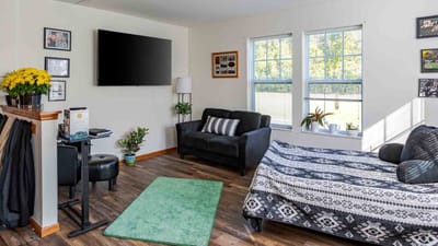 Cozy interior of a resident room with a couch and bed