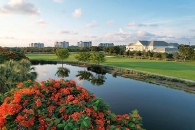 Aerial view of a retirement community with a pond and landscaping