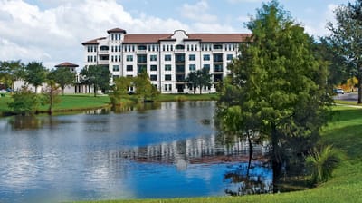 Exterior view of Westminster Towers near a pond