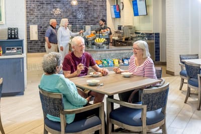 Residents enjoying snacks in a dining area