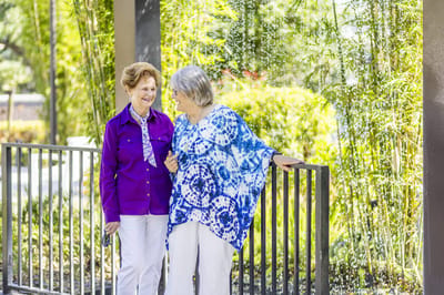 Two residents enjoying conversation in a garden