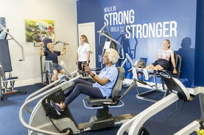 Residents exercising in a well-equipped gym