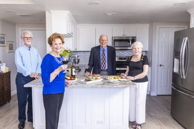 Residents enjoying appetizers in a kitchen setting