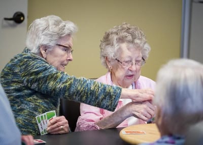 Residents enjoying a card game in a common area