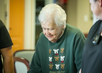 Resident enjoying an activity with staff members
