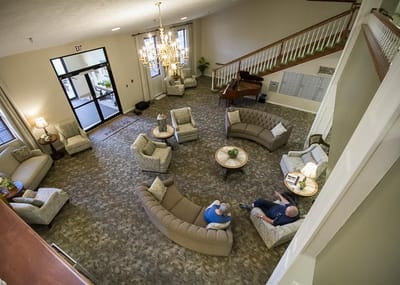 Residents seated in a well-decorated lobby area