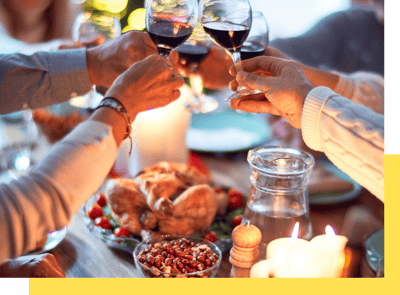 A group celebration with toasts and food on the table