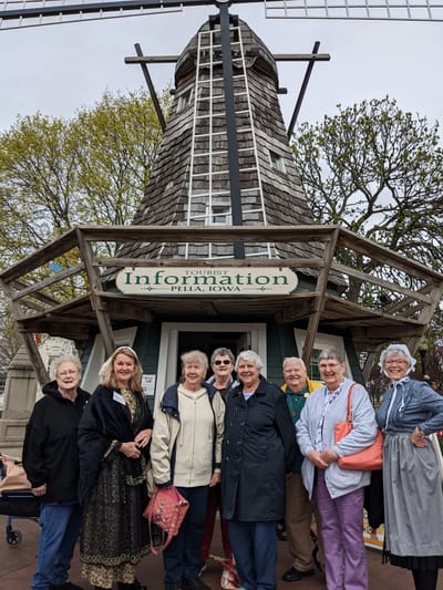 Group of seniors in front of a windmill information center