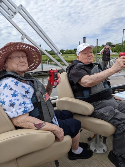 Two residents enjoying a boat ride outdoors