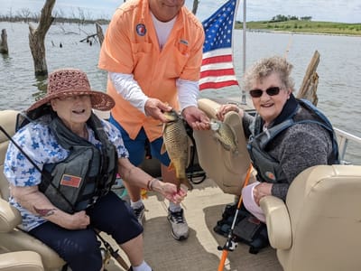 Residents fishing on a boat with caretaker