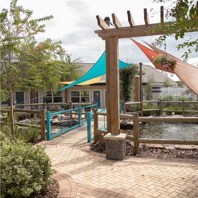 Sunny outdoor area with colorful shades and pond