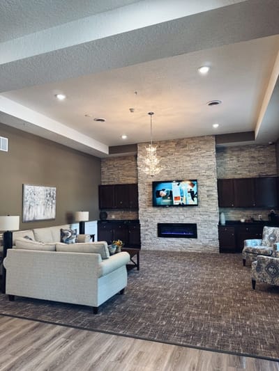 Bright common area with seating and a TV