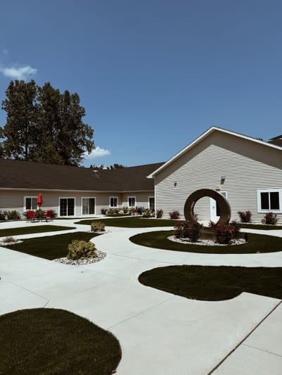 Outdoor courtyard with landscaped paths and sculpture