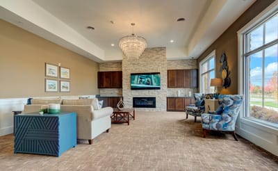 Common area lounge with sofas and a chandelier