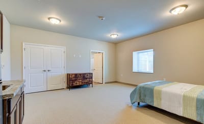 A bright, empty resident room with a window
