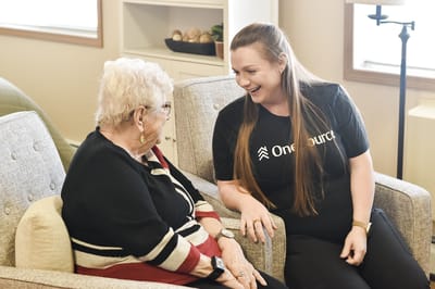 Staff member engaging with a resident in a cozy setting