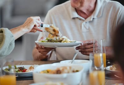 Residents enjoying a meal together at the dining table