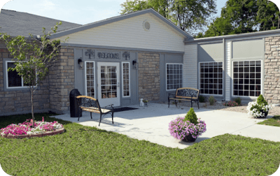 Exterior view of the facility entrance with garden space