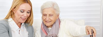 Staff member engaging with a resident in a cozy setting