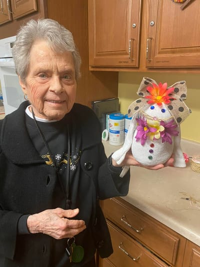 Resident making a craft project in the activity room